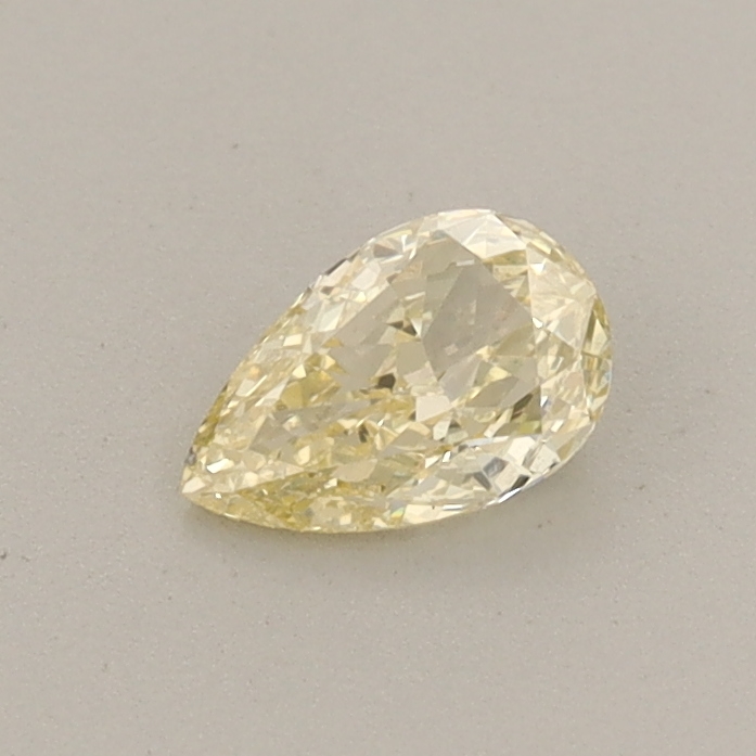 Actual 0.31 carat Fancy Yellow Pear lab-grown diamond